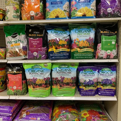 Neatly arranged pet-store shelves display colorful bags of dog treats, including mini bites, jerky, health bars, and dental chews.