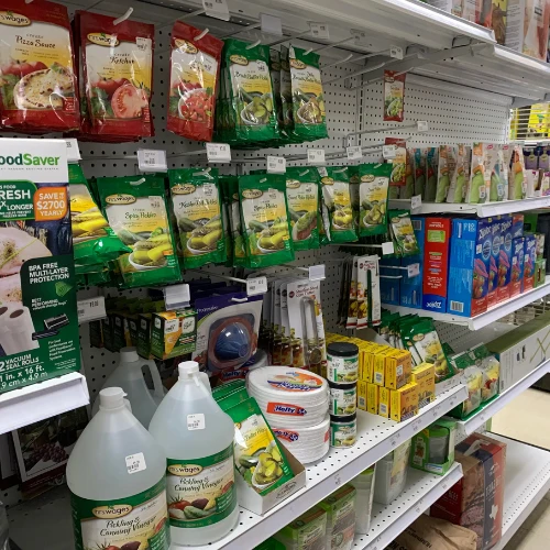 Pet store shelf stocked with colorful dog chew toys and treats, including Benebone, Bully Bites, dental chews, and assorted packaged snacks.