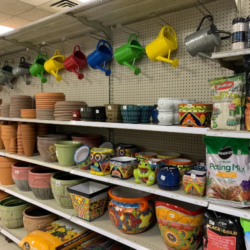 Grocery store aisle stocked with sauces, dressings, canned goods, baking products, cleaners, and packaged foods on crowded shelves.