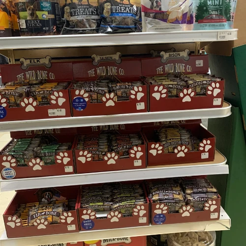 Retail shelf stocked with Nature's Miracle pet stain and odor removers, shampoos, oral care products, and household cleaners in a store aisle.