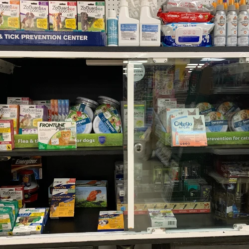 Store shelf stocked with The Wild Bone Co. dog treats in red boxes, featuring elk, salmon, bison, and lamb flavors; pet aisle display.