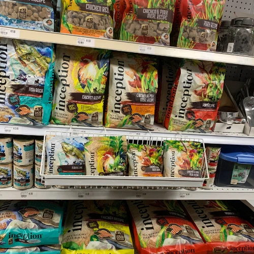 Pet store shelf stocked with Frontline Plus, Seresto, and ZoGuard flea and tick treatments for cats and dogs in colorful packaging.